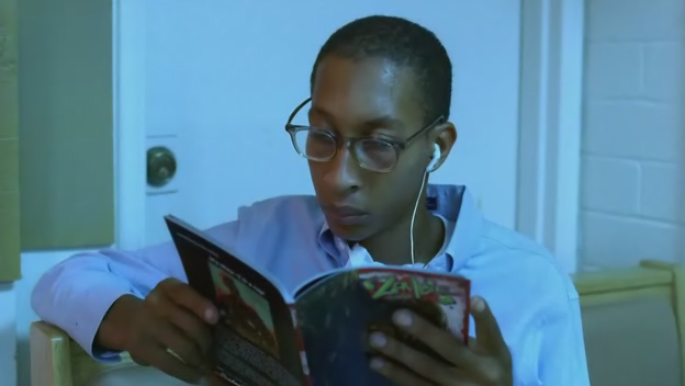 A young man in a diner reading the Zombie Cop graphic novel